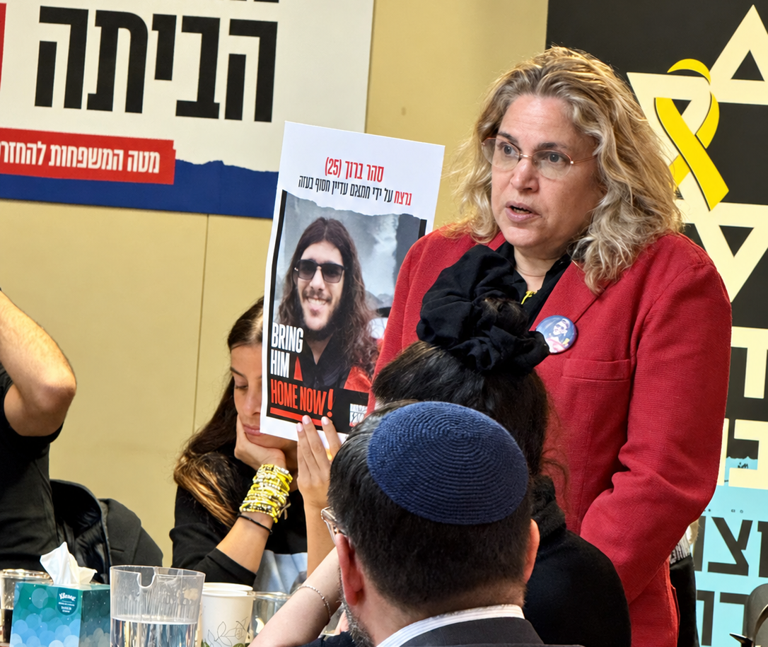 Hostage family gathering at the AZM offices, with a hostage poster and yellow ribbon